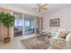 Open concept living room with sliding glass doors leading to an outdoor patio overlooking the water at 242 Hidden Bay Dr # 603, Osprey, FL 34229