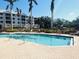 Outdoor pool with railings surrounded by lounge chairs and palm trees on a sunny day at 242 Hidden Bay Dr # 603, Osprey, FL 34229