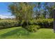 Backyard view highlighting the lush greenery and landscaping at 2560 Sunnyside St, Sarasota, FL 34239