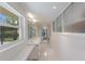 Bright bathroom with dual sinks, large window, and modern fixtures at 2560 Sunnyside St, Sarasota, FL 34239