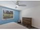 Cozy bedroom with natural light, neutral decor, and a stylish dresser at 2560 Sunnyside St, Sarasota, FL 34239