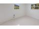 Bright bedroom featuring two windows offering natural light and a simple, clean aesthetic at 2560 Sunnyside St, Sarasota, FL 34239