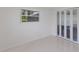 Clean bedroom with a closet, neutral colors, and bright natural light, perfect for relaxation at 2560 Sunnyside St, Sarasota, FL 34239