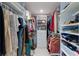 Walk-in closet offering ample storage with built-in shelving and hanging rods at 2560 Sunnyside St, Sarasota, FL 34239