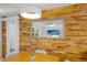 Bright dining area featuring wood accent wall, contemporary lighting and a modern mirror at 2560 Sunnyside St, Sarasota, FL 34239