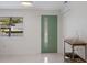 Bright entryway featuring a unique door with a vertical window and modern finishes at 2560 Sunnyside St, Sarasota, FL 34239