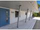 An inviting front porch features a stylish blue door and modern architectural details at 2560 Sunnyside St, Sarasota, FL 34239