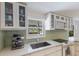 Bright kitchen featuring white cabinetry, modern appliances, and window with backyard views at 2560 Sunnyside St, Sarasota, FL 34239