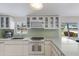 Bright, modern kitchen with stainless steel appliances, quartz countertops, and a garden window at 2560 Sunnyside St, Sarasota, FL 34239