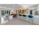 Open-concept living space with a kitchen featuring an island with bar stool seating, and sliding glass doors at 2560 Sunnyside St, Sarasota, FL 34239