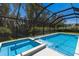Sparkling screened pool and attached spa provide a refreshing retreat with lush backyard views at 2560 Sunnyside St, Sarasota, FL 34239