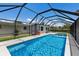 Backyard featuring a large screened pool, patio, and green space providing ample outdoor enjoyment at 2560 Sunnyside St, Sarasota, FL 34239