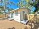 Backyard with wooden fence, small platform, and sliding door access at 2721 7Th W St, Bradenton, FL 34205