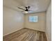 Cozy bedroom featuring a ceiling fan, large window, and contemporary flooring at 2721 7Th W St, Bradenton, FL 34205