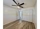 Bedroom featuring a ceiling fan, wood-look floors, and closet storage space at 2721 7Th W St, Bradenton, FL 34205