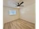 Cozy bedroom with a ceiling fan, large window, and laminate flooring at 2721 7Th W St, Bradenton, FL 34205