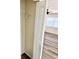 Bedroom view of closet storage and open access to room with ceiling fan and window at 2721 7Th W St, Bradenton, FL 34205