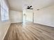 Bright living room showcases modern floors, fan, and leads to another area with a large window at 2721 7Th W St, Bradenton, FL 34205