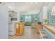 Cozy living room featuring tile floors, ceiling fan, and open concept access to kitchen at 305 Palmetto W Rd, Nokomis, FL 34275