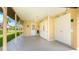 Spacious carport with ample storage, a ceiling fan, and access to the main house, providing convenient sheltered parking at 3213 Cambridge Ave, Bradenton, FL 34207