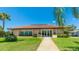 Inviting clubhouse featuring a well-manicured lawn and palm trees, perfect for community gatherings at 3213 Cambridge Ave, Bradenton, FL 34207