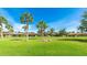 Well-maintained community with lush green lawns, mature palm trees, and charming single-story homes at 3213 Cambridge Ave, Bradenton, FL 34207