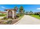 Cambridge Village community sign with lush landscaping and street view at 3213 Cambridge Ave, Bradenton, FL 34207