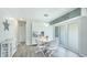 Charming dining area with modern lighting, sleek white furniture, and sliding glass door at 3213 Cambridge Ave, Bradenton, FL 34207