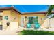 Inviting front entrance with blue Adirondack chairs, a tiled walkway, and charming coastal decorations at 3213 Cambridge Ave, Bradenton, FL 34207