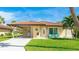 Charming home with a terracotta roof, a covered carport, and inviting blue Adirondack chairs on the front porch at 3213 Cambridge Ave, Bradenton, FL 34207
