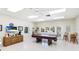 Community game room featuring a pool table, TV, seating, and ample natural light at 3213 Cambridge Ave, Bradenton, FL 34207