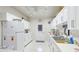 Functional kitchen equipped with white cabinets, stainless steel sink, and essential appliances at 3213 Cambridge Ave, Bradenton, FL 34207
