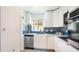 Modern kitchen boasts stainless steel appliances, sleek cabinetry, and stylish backsplash at 3213 Cambridge Ave, Bradenton, FL 34207