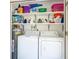 Laundry room with washer, dryer, water heater and ample storage shelving at 3213 Cambridge Ave, Bradenton, FL 34207