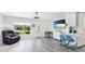 Inviting living room featuring a flat-screen TV, cozy chair, and ample natural light at 3213 Cambridge Ave, Bradenton, FL 34207