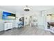 Open concept living room boasts a flat-screen TV and dining area with modern decor at 3213 Cambridge Ave, Bradenton, FL 34207