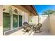 Private outdoor patio featuring a dining table, comfortable wicker chairs, and access to the home via sliding glass doors at 3213 Cambridge Ave, Bradenton, FL 34207