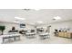Spacious recreation room featuring tables, chairs, a TV, and a cabinet area at 3213 Cambridge Ave, Bradenton, FL 34207