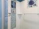 Walk-in shower featuring blue tile, shower caddy and tiled bench seating at 3213 Cambridge Ave, Bradenton, FL 34207