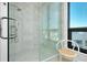 Glass enclosed shower with marble tiling in a modern bathroom with city views at 33 S Palm Ave # 1602, Sarasota, FL 34236