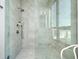 Modern bathroom featuring a spacious walk-in shower with marble tiling and glass enclosure, creating an open feel at 33 S Palm Ave # 1602, Sarasota, FL 34236