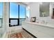 Elegant bathroom featuring double sinks, modern fixtures, and a large window with city views, all enhanced by a stylish rug at 33 S Palm Ave # 1602, Sarasota, FL 34236