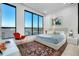Bright bedroom boasts expansive windows with city views, complemented by stylish decor and a cozy rug at 33 S Palm Ave # 1602, Sarasota, FL 34236
