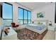 Modern bedroom boasting a plush bed, a chic accent rug, and expansive windows with stunning views at 33 S Palm Ave # 1602, Sarasota, FL 34236