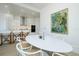 Dining area with modern table set up open to kitchen with stainless appliances and white cabinetry at 33 S Palm Ave # 1602, Sarasota, FL 34236