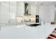 Modern kitchen with white countertops, sleek white cabinets, and high-end stainless steel appliances at 33 S Palm Ave # 1602, Sarasota, FL 34236