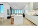 Open concept kitchen with center island, modern white cabinets, and stainless steel appliances at 33 S Palm Ave # 1602, Sarasota, FL 34236