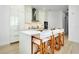 Modern kitchen featuring stainless steel appliances, center island, bright lighting, and wood-look tile floors at 33 S Palm Ave # 1602, Sarasota, FL 34236