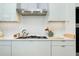 Sleek kitchen featuring gas range, stainless vent hood and integrated appliances at 33 S Palm Ave # 1602, Sarasota, FL 34236