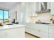 Bright kitchen with stainless steel hood, modern cabinets and island with sink overlooking city views at 33 S Palm Ave # 1602, Sarasota, FL 34236